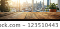 Wooden Table Surface with Sunset Blurry Cityscape and Nature Background, Warm Tones, and Soft Focus Lights Creating a Cozy Atmosphere for Relaxation 123510443