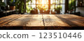 Wooden Table Surface with Sunset Blurry Cityscape and Nature Background, Warm Tones, and Soft Focus Lights Creating a Cozy Atmosphere for Relaxation 123510446