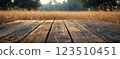 Wooden Table Surface with Sunset Blurry Cityscape and Nature Background, Warm Tones, and Soft Focus Lights Creating a Cozy Atmosphere for Relaxation 123510451
