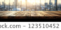 Wooden Table Surface with Sunset Blurry Cityscape and Nature Background, Warm Tones, and Soft Focus Lights Creating a Cozy Atmosphere for Relaxation 123510452