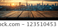 Wooden Table Surface with Sunset Blurry Cityscape and Nature Background, Warm Tones, and Soft Focus Lights Creating a Cozy Atmosphere for Relaxation 123510453