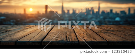Wooden Table Surface with Sunset Blurry Cityscape and Nature Background, Warm Tones, and Soft Focus Lights Creating a Cozy Atmosphere for Relaxation Wooden Table Surface with Sunset Blurry Cityscape and Nature Background, Warm Tones, and Soft Focus Lights Creating a Cozy Atmosphere for Relaxation 123510453