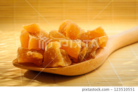 Closeup candied ginger on wooden spoon Closeup candied ginger on wooden spoon 123510551
