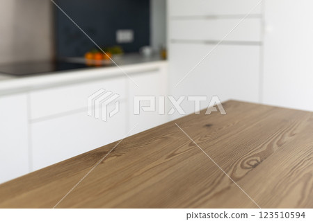 Empty wooden table with the bright white interior of the kitchen as a blurred background. Can be used for product display montage. Business presentation. 123510594