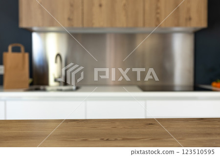 Empty wooden table with the bright white interior of the kitchen as a blurred background. Can be used for product display montage. Business presentation. Empty wooden table with the bright white interior of the kitchen as a blurred background. Can be used for product display montage. Business presentation. 123510595