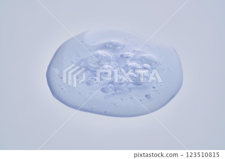 A drop of blue serum with bubbles. A drop of blue serum with bubbles. 123510815