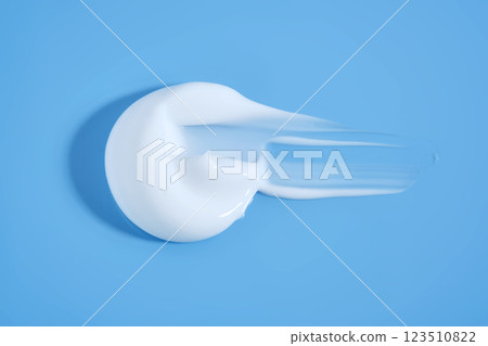 A smear of white cream on a blue background. A smear of white cream on a blue background. 123510822