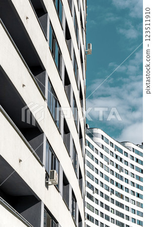Contemporary multistory residential building with a unique wavy facade and geometric design, 123511910