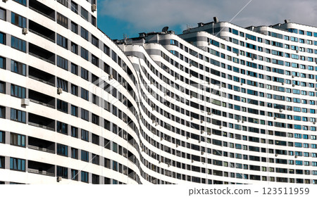 Modern high-rise condominium with a wavy, curved shape in a metropolitan city. Unique architecture, Modern high-rise condominium with a wavy, curved shape in a metropolitan city. Unique architecture, 123511959