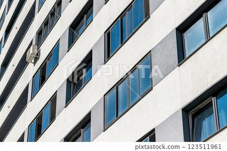 Modern high-rise multistory condo with a sleek facade in the heart of the city. New development Modern high-rise multistory condo with a sleek facade in the heart of the city. New development 123511961