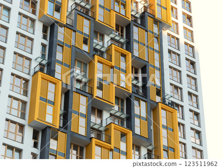 Modern high-rise residential building with bright yellow balconies in an urban metropolis. Modern high-rise residential building with bright yellow balconies in an urban metropolis. 123511962