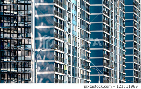 Modern multistory condominium in downtown metropolis. Concrete facade with large windows offering Modern multistory condominium in downtown metropolis. Concrete facade with large windows offering 123511969