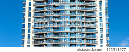 Panoramic view of modern high-rise residential buildings in an urban metropolis. Glass windows Panoramic view of modern high-rise residential buildings in an urban metropolis. Glass windows 123511977