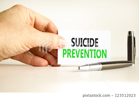 Suicide prevention symbol. Concept words Suicide prevention on beautiful white card. Psychologist hand. Beautiful white paper background. Psychological and suicide prevention concept. Copy space. Suicide prevention symbol. Concept words Suicide prevention on beautiful white card. Psychologist hand. Beautiful white paper background. Psychological and suicide prevention concept. Copy space. 123512023