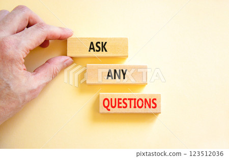 Ask any questions symbol. Concept words Ask any questions on beautiful wooden blocks. Beautiful white background. Businessman hand. Business ask any questions concept. Copy space. 123512036
