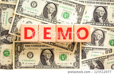 Demo symbol. Concept word Demo on beautiful wooden blocks. Dollar bills. Beautiful background from dollar bills. Business and demo concept. Copy space. Demo symbol. Concept word Demo on beautiful wooden blocks. Dollar bills. Beautiful background from dollar bills. Business and demo concept. Copy space. 123512077