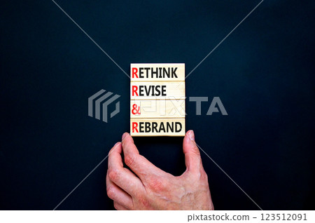 Rethink revise rebrand symbol. Concept word Rethink Revise and Rebrand on beautiful wooden blocks. Beautiful black background. Business brand rethink revise rebrand concept. Copy space. Rethink revise rebrand symbol. Concept word Rethink Revise and Rebrand on beautiful wooden blocks. Beautiful black background. Business brand rethink revise rebrand concept. Copy space. 123512091