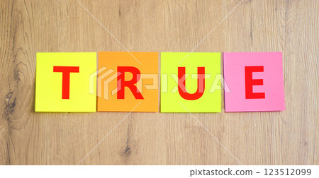 True symbol. Concept word True on beautiful colored paper. Beautiful wooden table wooden background. Business, lifestyle, support and true concept. Copy space. True symbol. Concept word True on beautiful colored paper. Beautiful wooden table wooden background. Business, lifestyle, support and true concept. Copy space. 123512099