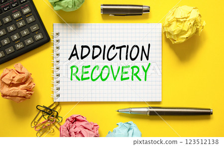 Addiction recovery symbol. Concept words Addiction recovery on beautiful white note. Black calculator. Colored paper. Beautiful yellow background. Psychology addiction recovery concept. Copy space. 123512138