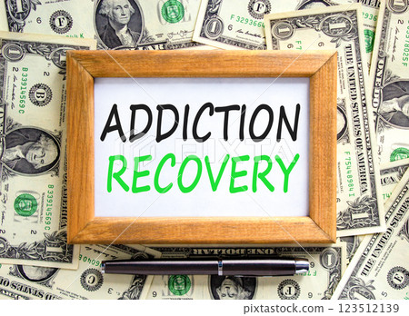 Addiction recovery symbol. Concept words Addiction recovery on beautiful wooden picture frame. Dollar bills. Beautiful background from dollar bills. Psychology addiction recovery concept. Copy space. 123512139