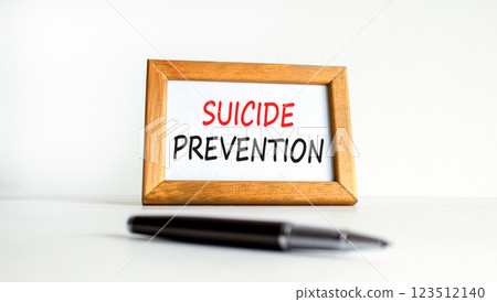 Suicide prevention symbol. Concept words Suicide prevention on beautiful wooden picture frame. Black pen. Beautiful white background. Psychological suicide prevention concept Copy space 123512140