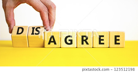 Agree or disagree symbol. Concept words Agree Disagree on beautiful wooden blocks. Beautiful yellow table white background. Businessman hand. Business agree or disagree concept. Copy space 123512198