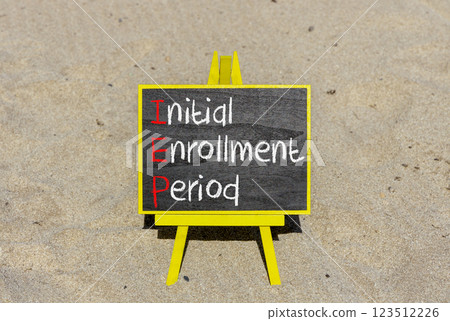 IEP symbol. Concept words IEP Initial enrollment period on beautiful black chalk blackboard. Beautiful sand beach background. Medical and IEP Initial enrollment period concept. Copy space. 123512226