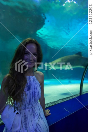 Woman Posing by Shark Tank at Antalya Aquarium Woman Posing by Shark Tank at Antalya Aquarium 123512268