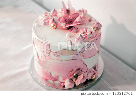 Birthday cake decorated with pink sugar flowers and butterflies. 123512761