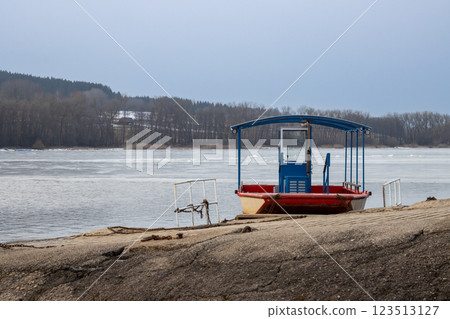 Frozen Lipno and a boat on the coast, Czechia Frozen Lipno and a boat on the coast, Czechia 123513127