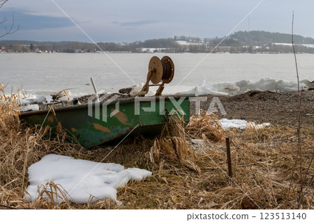 Frozen Lipno and a boat on the coast, Czechia Frozen Lipno and a boat on the coast, Czechia 123513140