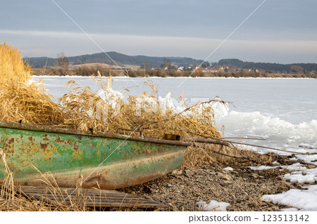 Frozen Lipno and a boat on the coast, Czechia Frozen Lipno and a boat on the coast, Czechia 123513142