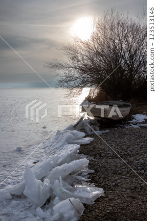 Frozen Lipno and a boat on the coast, Czechia Frozen Lipno and a boat on the coast, Czechia 123513146