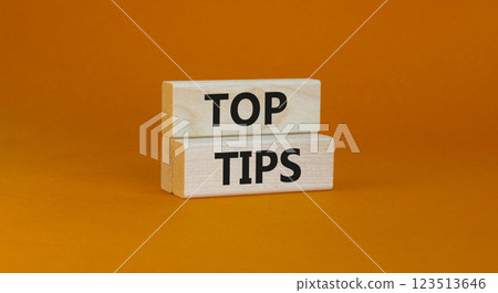 Top tips symbol. Concept words Top tips on wooden blocks on a beautiful orange background. Business and Top tips concept, copy space. Top tips symbol. Concept words Top tips on wooden blocks on a beautiful orange background. Business and Top tips concept, copy space. 123513646