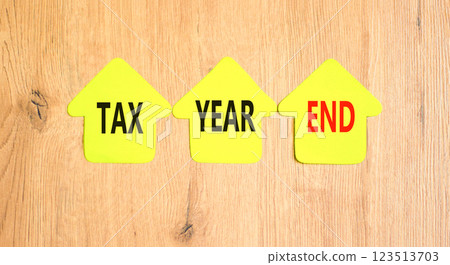 Tax year end symbol. Concept words Tax year end on beautiful yellow paper houses. Beautiful wooden background. Business tax year end concept. Copy space. 123513703