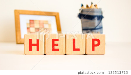 Help symbol. Concept word Help on beautiful wooden blocks. Beautiful picture frame and colored pencils. Beautiful white table white background. Business, lifestyle, support help concept. Copy space. Help symbol. Concept word Help on beautiful wooden blocks. Beautiful picture frame and colored pencils. Beautiful white table white background. Business, lifestyle, support help concept. Copy space. 123513713