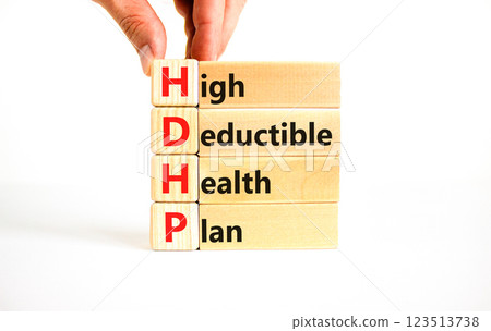 HDHP High Deductible Health Plan symbol. Concept word HDHP High Deductible Health Plan on beautiful blocks. Beautiful white background. Business HDHP High Deductible Health Plan concept. Copy space. 123513738