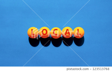 Local symbol. Concept word Local on beautiful yellow tennis ping pong balls. Beautiful wooden table wooden background. Business lifestyle local concept. Copy space. Local symbol. Concept word Local on beautiful yellow tennis ping pong balls. Beautiful wooden table wooden background. Business lifestyle local concept. Copy space. 123513768