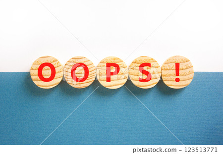 Oops symbol. Concept word Oops on beautiful wooden circles. Beautiful blue and white background. Business lifestyle oops concept. Copy space. Oops symbol. Concept word Oops on beautiful wooden circles. Beautiful blue and white background. Business lifestyle oops concept. Copy space. 123513771