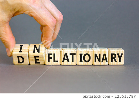 Deflationary or inflationary symbol. Concept words Deflationary Inflationary on wooden blocks. Beautiful grey background. Businessman hand. Business deflationary inflationary concept. Copy space 123513787