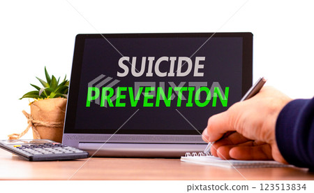 Suicide prevention symbol. Concept words Suicide prevention on beautiful tablet. Psychologist hand. Beautiful wooden table white background. Psychological suicide prevention concept. Copy space. Suicide prevention symbol. Concept words Suicide prevention on beautiful tablet. Psychologist hand. Beautiful wooden table white background. Psychological suicide prevention concept. Copy space. 123513834