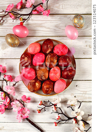 Easter celebration concept, marbled Easter eggs painted with onion peel and pink matcha on concrete background with sakura branches, ideas for homemade Easter preparations Easter celebration concept, marbled Easter eggs painted with onion peel and pink matcha on concrete background with sakura branches, ideas for homemade Easter preparations 123514075