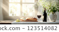 Wine, Bread, Grapes, and Flowers on Table 123514082