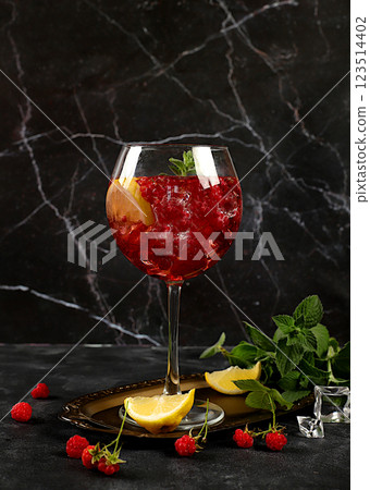 Royal lemonade cocktail with tequila, gin, rum, vodka, liqueur, lime, ice and fresh raspberries, bar and party concept, advertising card for restaurant and cafe, black background, . Royal lemonade cocktail with tequila, gin, rum, vodka, liqueur, lime, ice and fresh raspberries, bar and party concept, advertising card for restaurant and cafe, black background, . 123514402