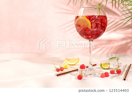 Royal lemonade cocktail with tequila, gin, rum, vodka, liqueur, lime, ice and fresh raspberries, bar and party concept, advertising card for restaurant and cafe, elegant background with shadows, . 123514403