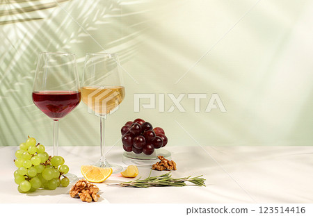 Modern still life with glasses of white and red wine, alcoholic cocktail Margarita and grapes on background with long hard shadows, minimalist concept for bar, cafe, advertising banner, 123514416
