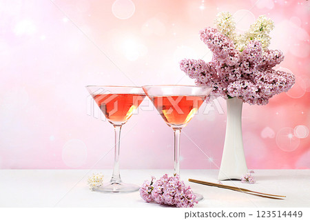 Festive alcoholic cocktail red martini in glasses on a bright background with a bouquet of lilacs, summer bar concept, alcoholic drinks at a party, restaurant and cafe advertising, selective focus 123514449