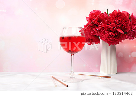 Festive alcoholic cocktail, red wine in glasses on a bright background with a bouquet of burgundy peonies, summer bar concept, alcoholic drinks at a party, restaurant and cafe advertising, selective Festive alcoholic cocktail, red wine in glasses on a bright background with a bouquet of burgundy peonies, summer bar concept, alcoholic drinks at a party, restaurant and cafe advertising, selective 123514462