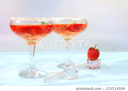 Modern still life with pink martini, alcoholic cocktail, strawberries on elegant modern background, minimal concept for bar and holiday party, cafe, advertising banner, selective focus, space for text Modern still life with pink martini, alcoholic cocktail, strawberries on elegant modern background, minimal concept for bar and holiday party, cafe, advertising banner, selective focus, space for text 123514504