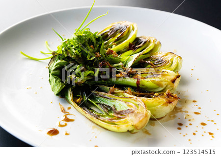 Fresh bok choy is elegantly plated, showcasing a vibrant green garnish inspired by Asian cuisine. Fresh bok choy is elegantly plated, showcasing a vibrant green garnish inspired by Asian cuisine. 123514515